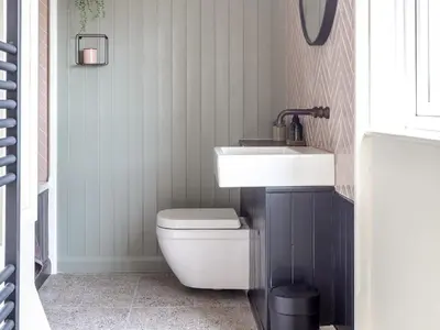 a bathroom with a white sink and a toilet at Stag Cottage in Penrith