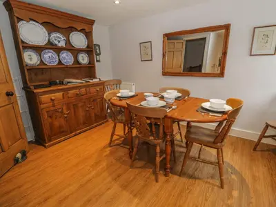 a dining room with a wooden table and chairs at Rowan Cottage in Grasmere