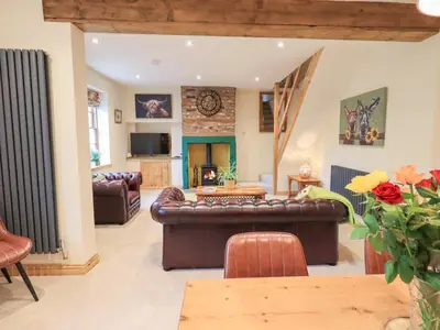 a living room with a couch and a table at Rose Cottage in Crosby