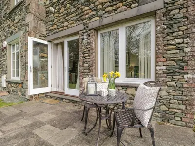 a patio with a table and two chairs at Garden Cottage in Keswick