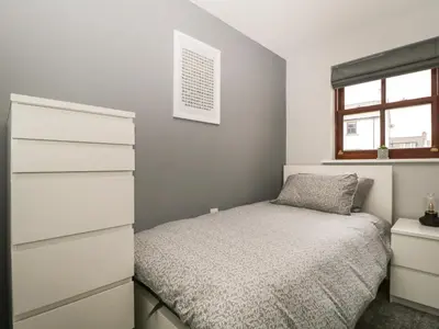 a bedroom with a bed and a dresser at Andra Ghyll in Keswick