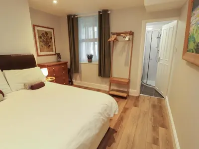 a bedroom with a large white bed and a window at Archers in Keswick