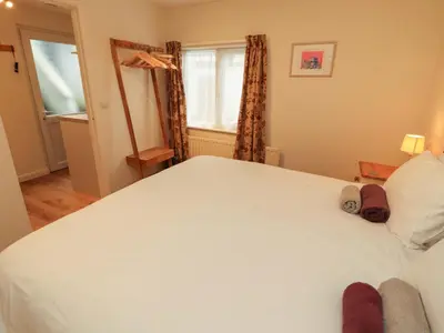 a bedroom with a large white bed and a window at Archers in Keswick