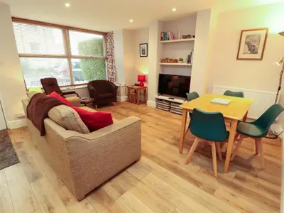a living room with a couch and a table at Archers in Keswick