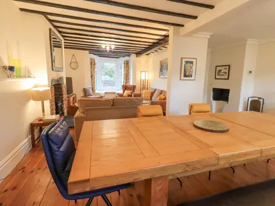 a living room with a wooden table and a couch at Greta Mill in Keswick