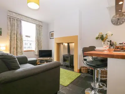 a living room with a couch and a table at Banks Place in Keswick