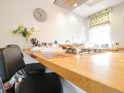 a kitchen with a counter with bowls and glasses on it at Banks Place in Keswick