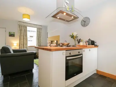 a kitchen with a sink and a stove top oven at Banks Place in Keswick