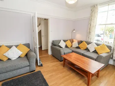 a living room with two couches and a coffee table at Pelham House in Keswick