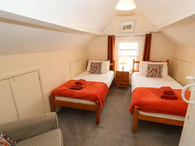 a room with two beds and a couch in it at Pelham House in Keswick
