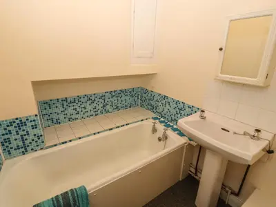 a bathroom with a tub and a sink at Pelham House in Keswick