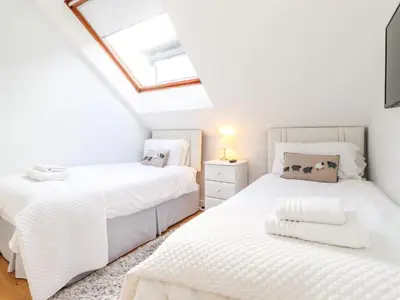 two beds in a attic bedroom with a skylight at Sky View in Keswick