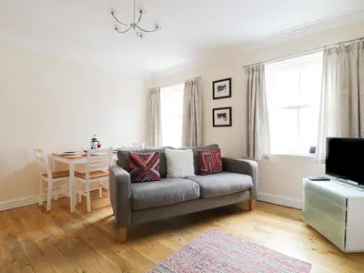 a living room with a couch and a table at Siskin in Keswick