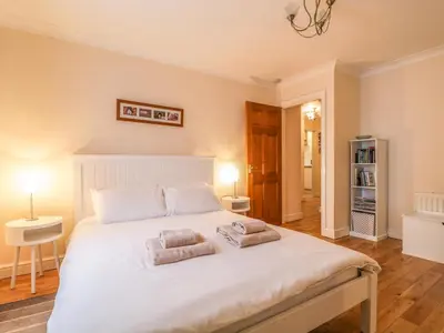 a bedroom with a large white bed with two pillows at Siskin in Keswick