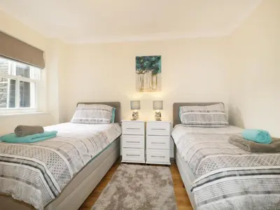 a bedroom with two beds and a window at Fox's Den in Keswick