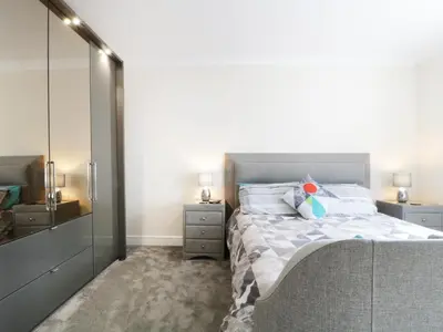 a bedroom with a large bed and a mirror at Fox's Den in Keswick