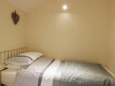 a small bedroom with a bed with two pillows at The Old Barn in Nether Wasdale