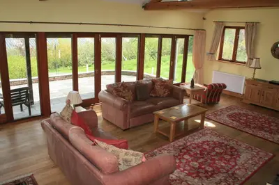a living room with couches and a table at The Byre in Keswick