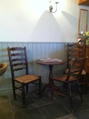 a table and two chairs sitting next to a table at Littletown Farm Guest House in Keswick