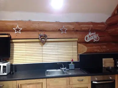 a kitchen with a sink and stars on the wall at lyne view, log cabin in Carlisle