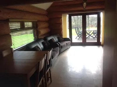 a living room with a couch and a table at lyne view, log cabin in Carlisle