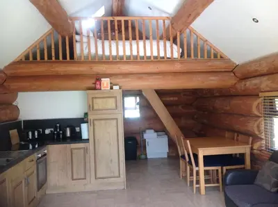 a kitchen with a staircase in a log cabin at lyne view, log cabin in Carlisle