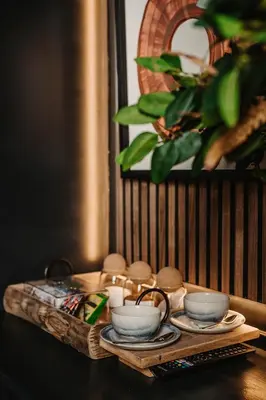 a table with a tray with cups and dishes on it at The Murray Arms Hotel in Gatehouse of Fleet
