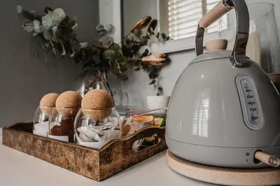 a tea kettle on a counter with eggs in a tray at The Murray Arms Hotel in Gatehouse of Fleet