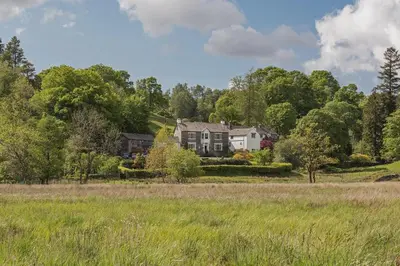 a house in the middle of a field at Eltermere Inn in Elterwater
