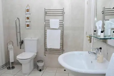 a white bathroom with a toilet and a sink at Douglas House in Castle Douglas