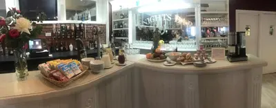 a counter in a store with a counter top with food at The Crown Hotel in Newton Stewart