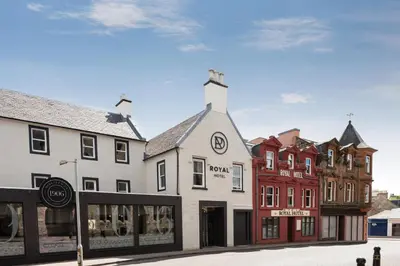 a building on a street with other buildings at Royal Hotel in Cumnock