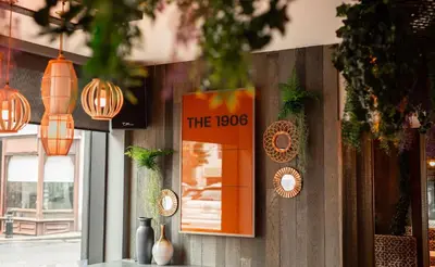 a sign on the wall of a restaurant with lights at Royal Hotel in Cumnock