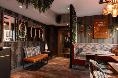 a restaurant with a bar with a table and chairs at Royal Hotel in Cumnock