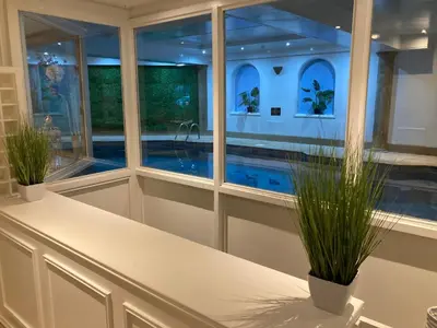a kitchen with a pool seen through windows at Washington Central Hotel and Sleepwell Inn in Workington