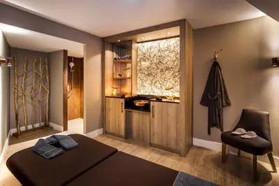 a room with a bed and a sink in it at Langdale Hotel & Spa in Ambleside