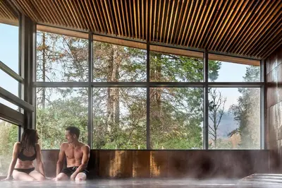 a man and a woman sitting in the water in a tub at Langdale Hotel & Spa in Ambleside
