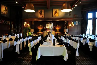 a dining room with white tables and chairs at Savoy Park Hotel in Ayr