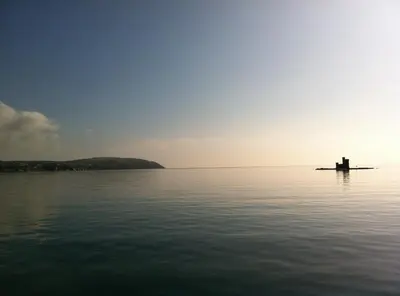 a view of a body of water with a lighthouse at Edelweiss Guest House in Douglas