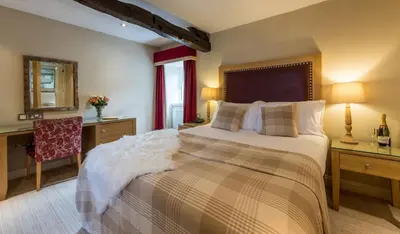 a bedroom with a bed and a desk and a chair at The Pennington Hotel in Ravenglass