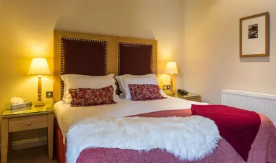 a bedroom with a large bed with two pillows at The Pennington Hotel in Ravenglass