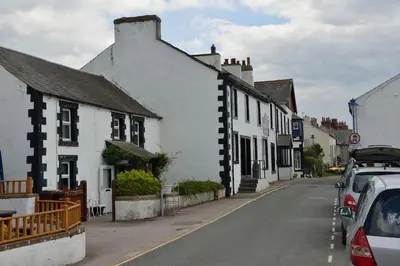 a street in a small town with white houses at The Pennington Hotel in Ravenglass