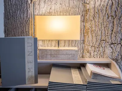 a desk with a lamp and a stack of books at The Sally in Carlisle