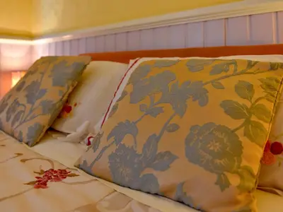 a bed with two pillows on top of it at The Warren Guest House in Carlisle