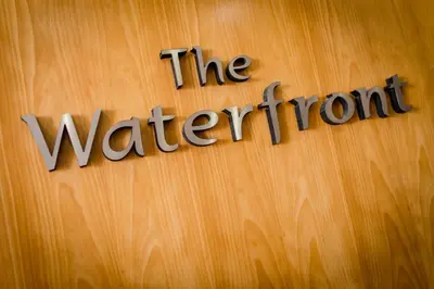 a wooden door with the watermont sign on it at The Waterfront in Portpatrick