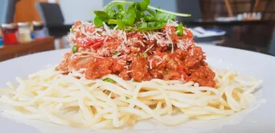 a plate of spaghetti with meat sauce on top at The Waterfront in Portpatrick