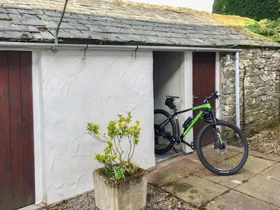 a bike parked outside of a small house at Melbreak in Lorton