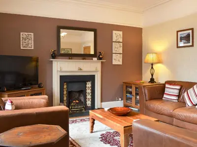 a living room with a couch and a fireplace at Bianca Rose in Keswick