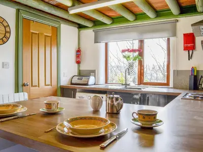 a kitchen with a wooden table with dishes on it at Lucy's Lodge - Uk1260 in Threlkeld