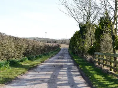 a dirt road with a fence on the side at Greengill Farm Holiday Cottage - Ukc2768 in Gilcrux